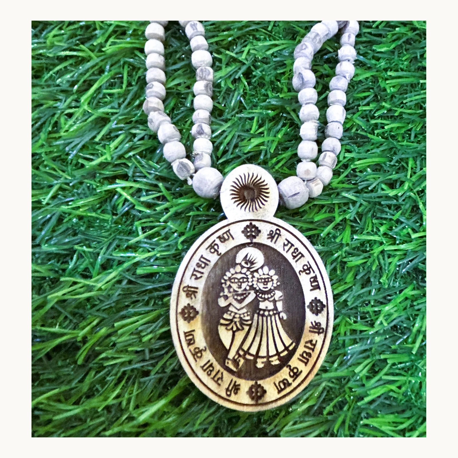 Closeup of natural Tulsi double-chain mala with Radha Krishna pendant