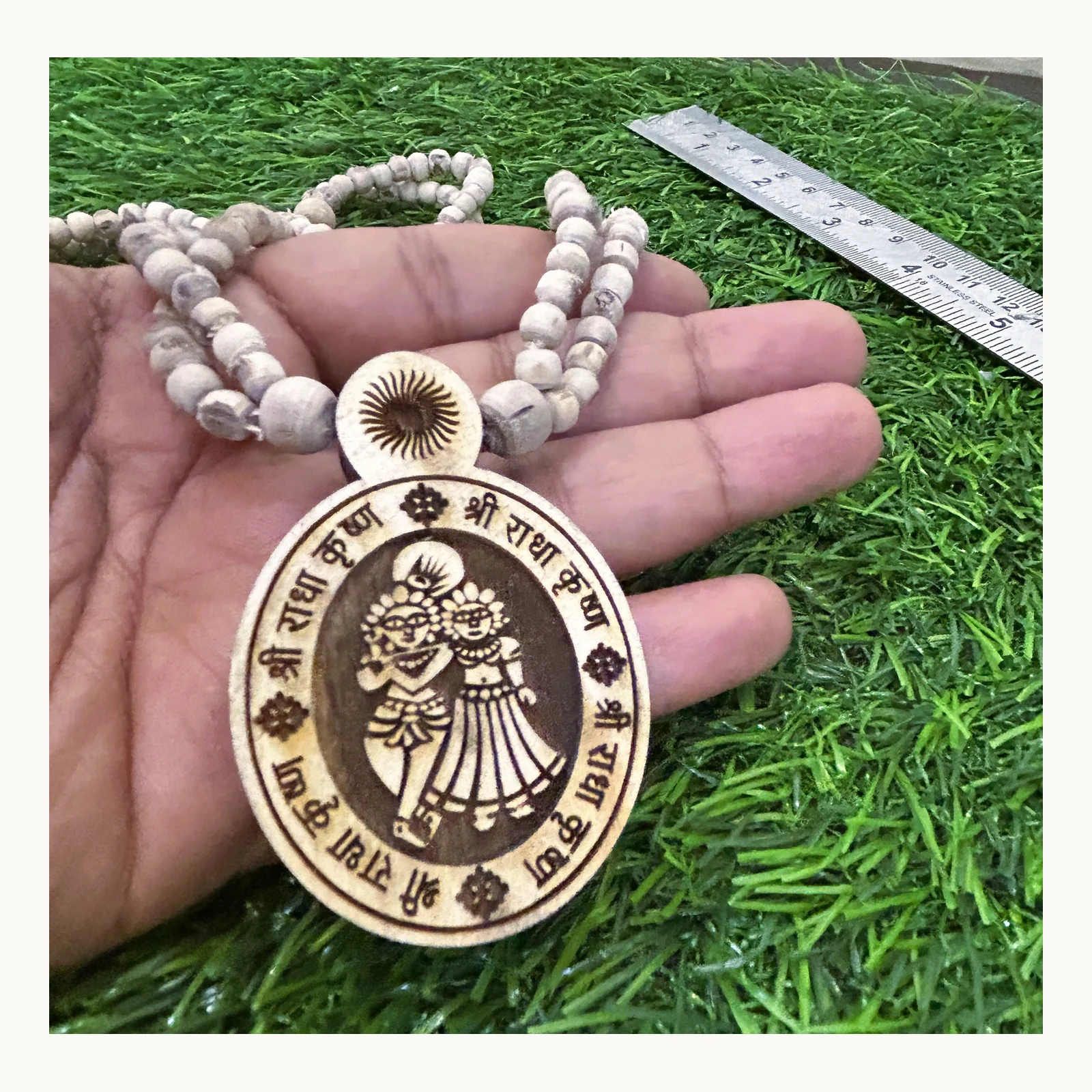 Detail view of natural Tulsi double-chain mala with Radha Krishna pendant